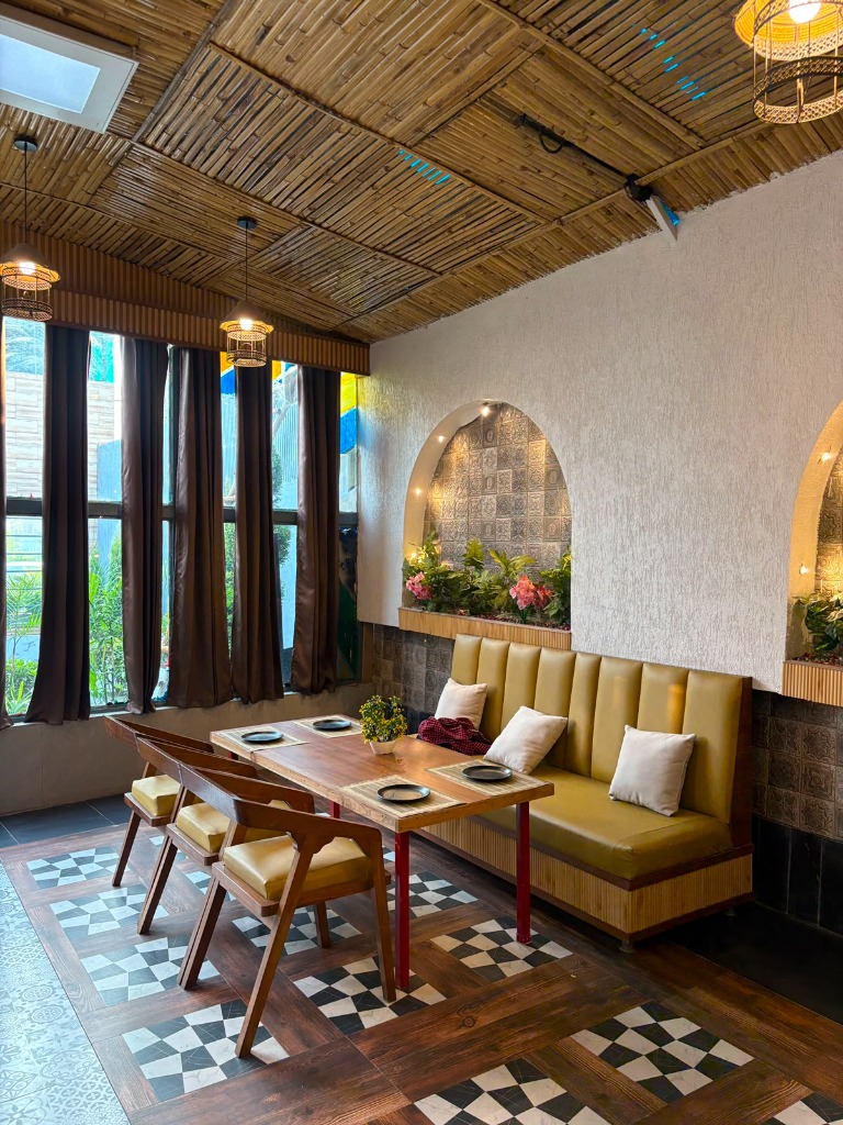 Sunlit bamboo ceiling dining booth with window and flower niche