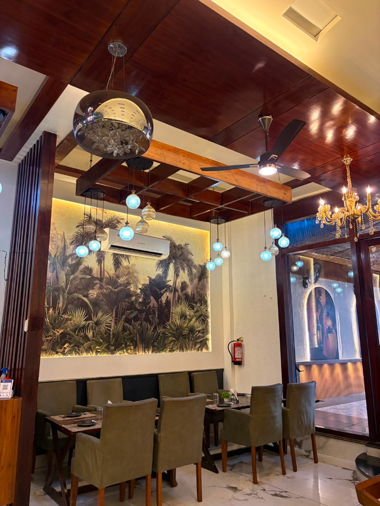Tropical palm mural dining room with pergola wooden rafters and orb lights